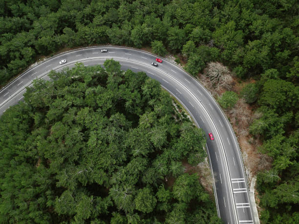 istock Red color challenge ,Vehicles going on mountain winding road roads 1305690437