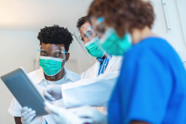 small group of medical scientist professionals working together in lab setting photo series - serious african ethnicity mid adult bright imagens e fotografias de stock