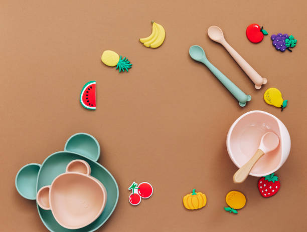 istock Flat lay composition with baby food accessory, plastic fruits, on light background. First baby food concept 1305691855