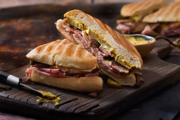 Classic Grilled Cuban Sandwich Classic Grilled Cuban Sandwich with Roast Pork, Honey Ham, Swiss Cheese, Dill Pickles and Mustard cuban culture photos stock pictures, royalty-free photos & images