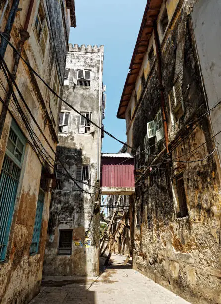 Stonetown (Tanzania, Zanzibar Archipelago). Streets and harbour in old Stone Town of Zanzibar City, historical colonial stony buildings, narrow streets with stores and shops.