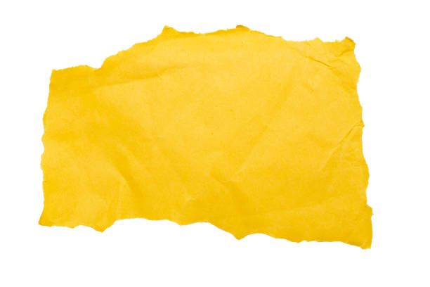 Torn piece of yellow paper on a white background. File contains clipping path. Space for text. stock photo
