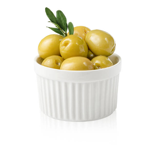 istock Green olives with leaves in bowl 1305697002