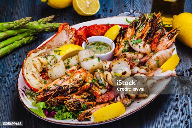 Download Seafood Platter Grilled Lobster Shrimps Scallops Langoustines Octopus Squid On White Plate Stock Photo