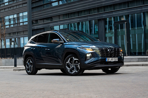 Berlin, Germany - 5th March, 2021: Blue SUV Hyundai Tucson Hybrid stopped on a street. This car is the most popular SUV from Hyundai brand.
