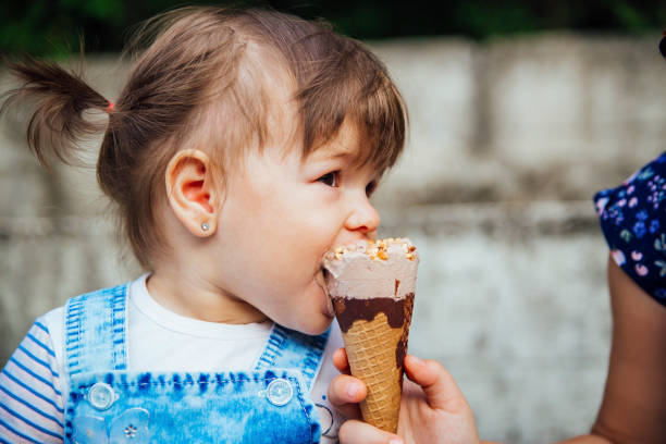 istock Small toddler girl eating ice cream 1305704643