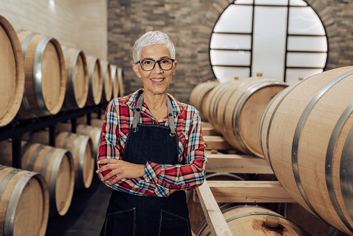 Portrait of a female senior entrepreneur working at her winery.