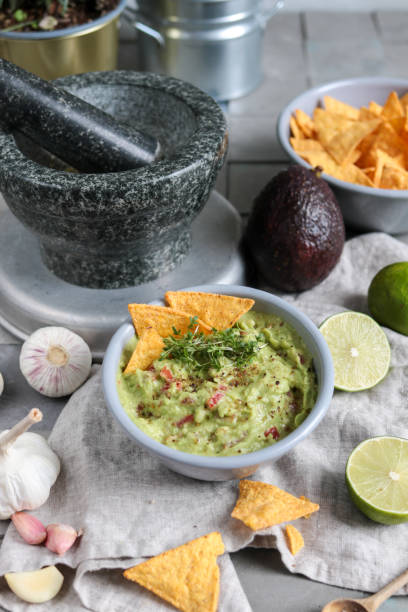 istock Homemade Guacamole Avocado Dip with Nacho Chips 1305706754