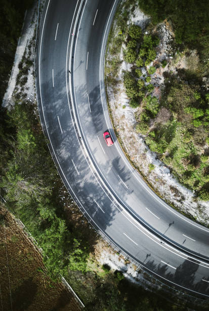 istock Red color challenge ,Vehicles going on mountain winding road roads 1305709354