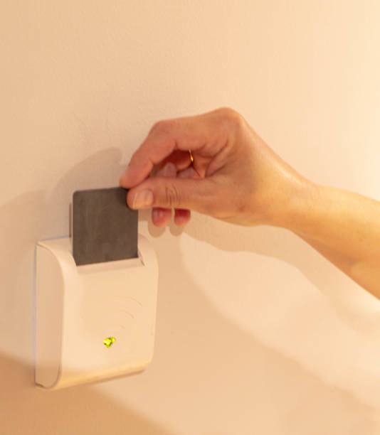 istock selective one-handed focus by inserting the hotel room card into an electronic device to turn on the light of your entire room 1305709622