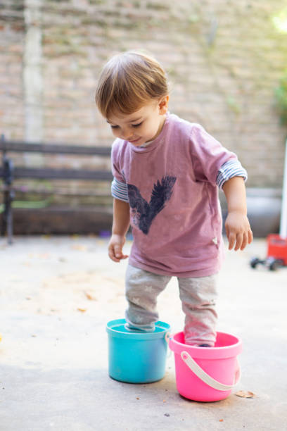 istock toddler playing with buckets 1305710444