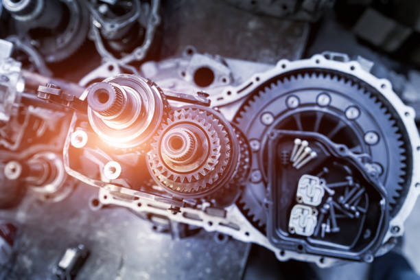 istock Closeup disassembled car automatic transmission gear part on workbench at garage or repair factory station for fix service or maintenance. Vehicle part detail. Complex industrial mechanism background 1305710678