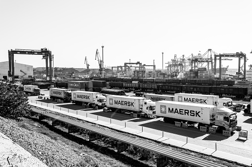 Panoramic view of TIS container terminal in largest dry cargo port of Ukraine. Black and white industrial landscape of port berth with Maersk container trucks. Odessa, Ukraine, 10 12 2018
