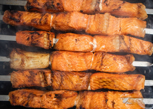 Fish kebab on skewers on the grill in winter