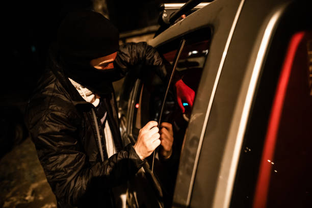 istock Thief stealing car trough the window 1305714182
