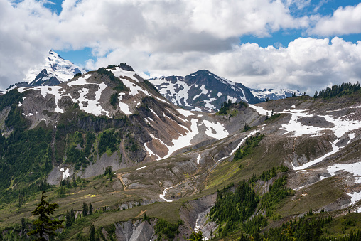 Snowcapped mountains and pine forests in Washington state in the North Cascades mountain range.