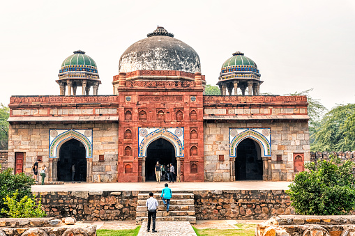 2nd February, 2020 - Delhi, India: This editorial image focuses on the Humayun's Tomb complex, one of Delhi's most iconic landmarks and a UNESCO World Heritage site. Built in 1570, the tomb set a precedent for future Mughal architecture, including the Taj Mahal. Tourists and visitors captured in the photograph are seen exploring the well-maintained gardens, engaging with the architectural intricacies, and taking snapshots to remember their visit. The image offers a glimpse into the balance of historical significance and modern-day tourism that characterises this important cultural site.
