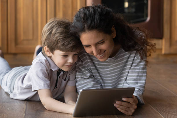 istock Close up mother and little son using tablet together 1305721780