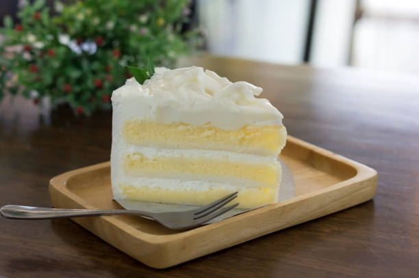 istock White coconut cake on wooden plate. 1305721910