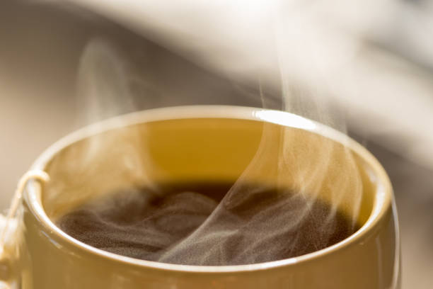 istock Steaming hot drink in cup close up view 1305724736
