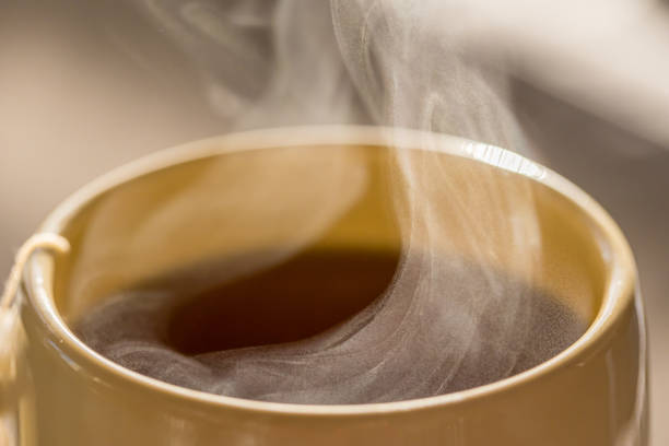 istock Steaming hot drink in ceramic cup close up 1305724739