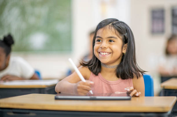 istock School Girl Using A Digital Tablet Stock Photo 1305725509