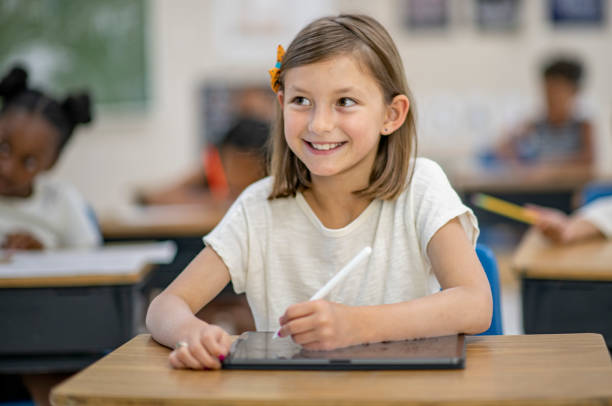 istock School Girl Using A Digital Tablet Stock Photo 1305725516