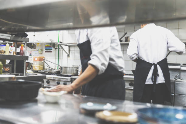 Chef's dishing up a main course at a banquet