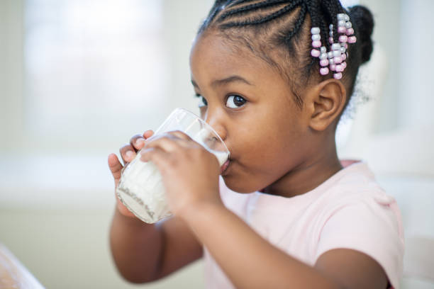 Milk Is The Best Stock Photo An adorable three year old toddler drinking a glass of milk at home. 2 glasses of milk stock pictures, royalty-free photos & images