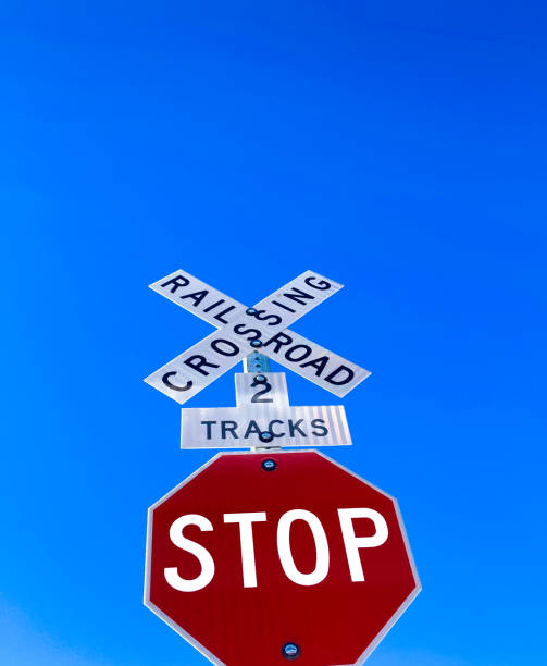 istock STOP Sign, RR Crossing, Vibrant Blue Sky 1305734551