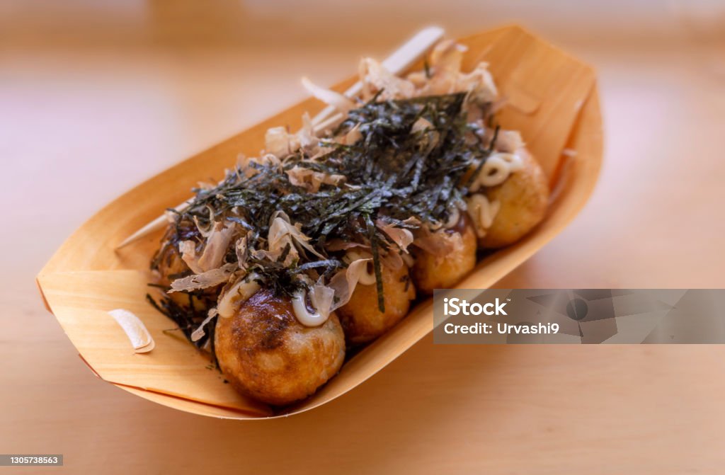 Japanese food Takoyaki on wooden table. Takoyaki Stock Photo