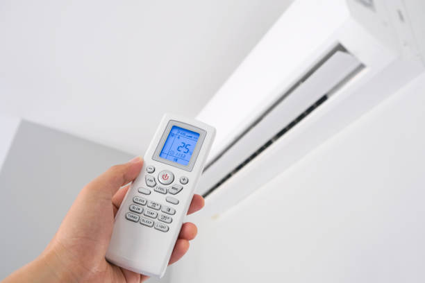 istock Man's hand using remote control open The air conditioner is cooled to 25 degrees Celsius in his bedroom. Health concepts and energy savings 1305738569
