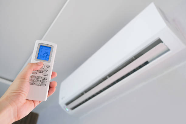 istock Man's hand using remote control open The air conditioner is cooled to 25 degrees Celsius in his bedroom. Health concepts and energy savings 1305738571