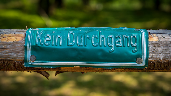 Sign: Kein Durchgang (German for no trespassing), pinned to tree trunk