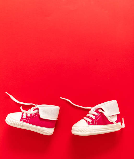 istock Baby shoes on blue color background, copy space 1305748951