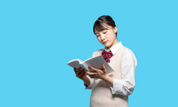 istock Asian high school girl reading a book. 1305752145
