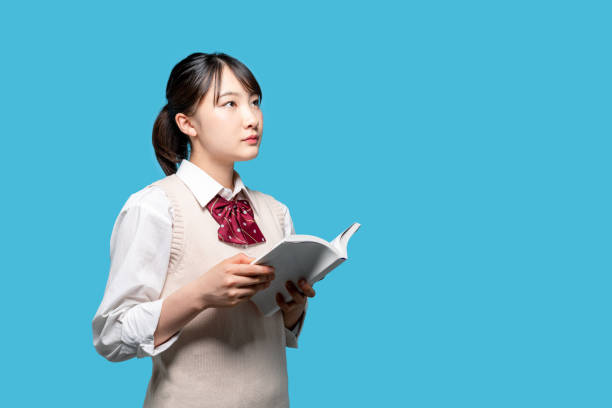 本を読んでアジアの女子高生。 - 女子生徒 ストックフォトと画像