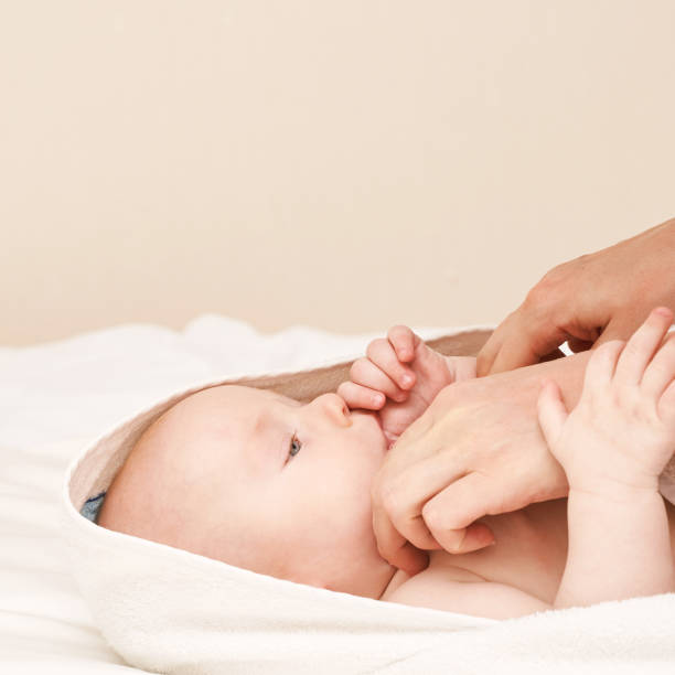 istock Cute small boy lying at bed. Childhood bath concept. Light background 1305753861