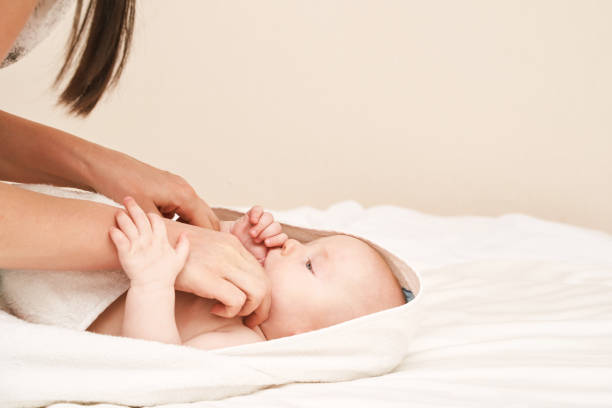 istock Cute small boy lying at bed. Childhood bath concept. Light background 1305753866