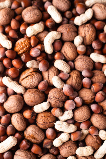 istock Mix unpeeled nuts close. peanuts, hazelnut, and walnut nut mixed 1305758148