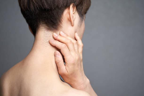 istock Middle-aged Japanese woman holding down her aching neck 1305759236