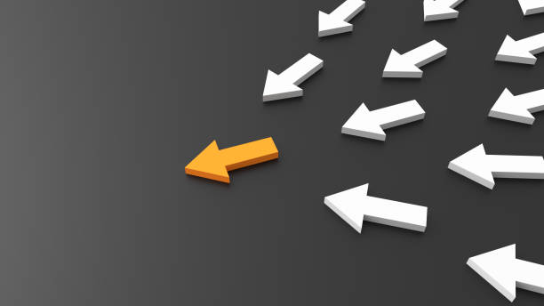 istock Leadership concept, orange leader arrow leading white arrows, on black background with empty copy space on left side 1305761099