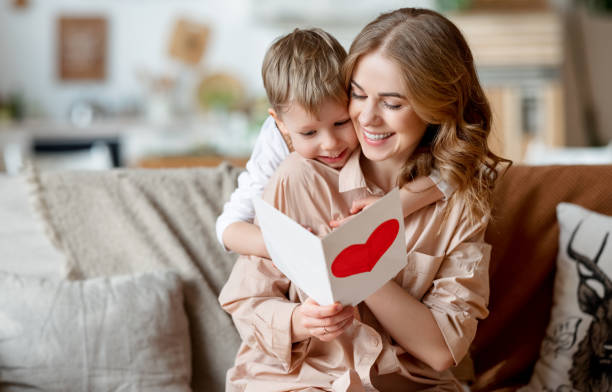 istock Mother and son reading greeting card 1305761171