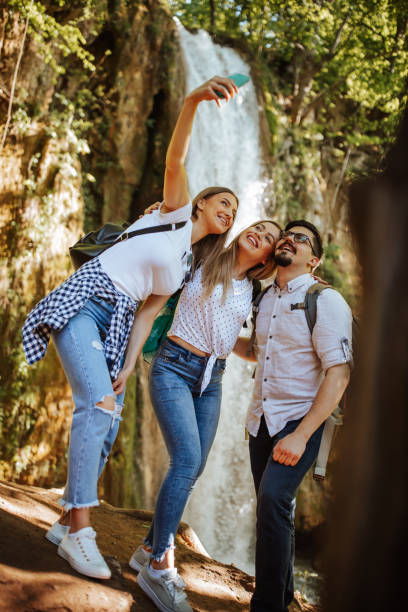 istock Cheerful friends taking selfie in nature 1305761989