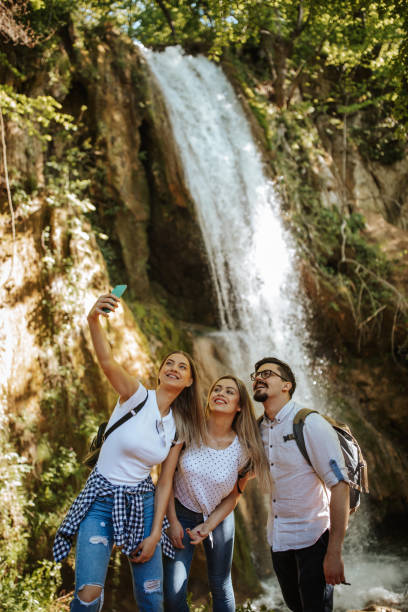istock Cheerful friends taking selfie in nature 1305762075