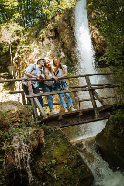 istock Cheerful friends taking selfie in nature 1305762936