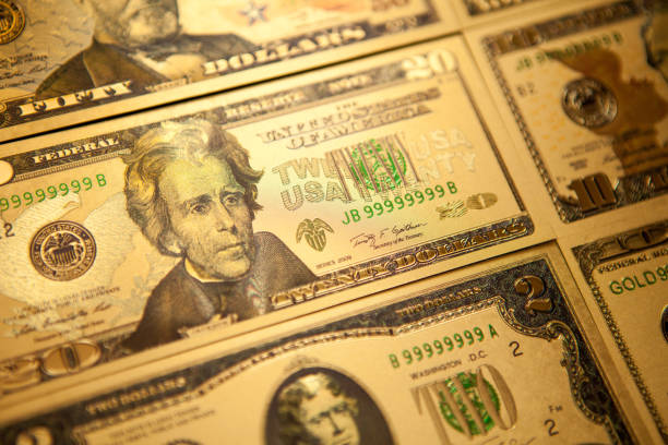 istock Currency US golden dollar banknotes close-up background. 1305764908