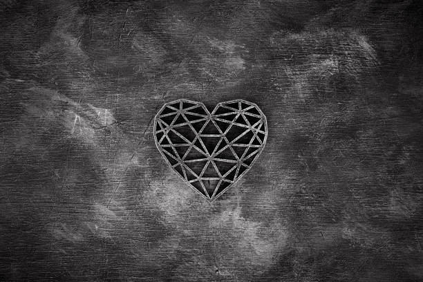 Wooden openwork heart on dark wooden background