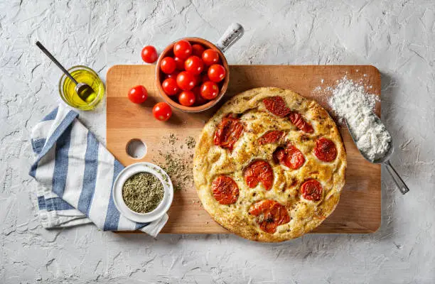 Bari-style focaccia bread and ingredients, flat lay.