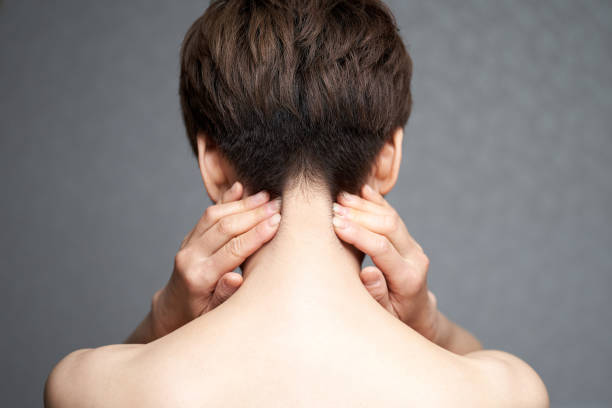 middle-aged japanese woman suffering from neck pain - massaging alternative medicine headache women imagens e fotografias de stock